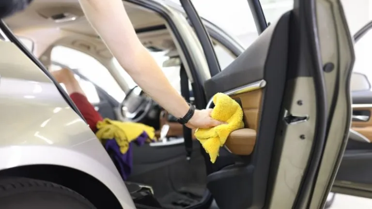 cleaning car with a towel