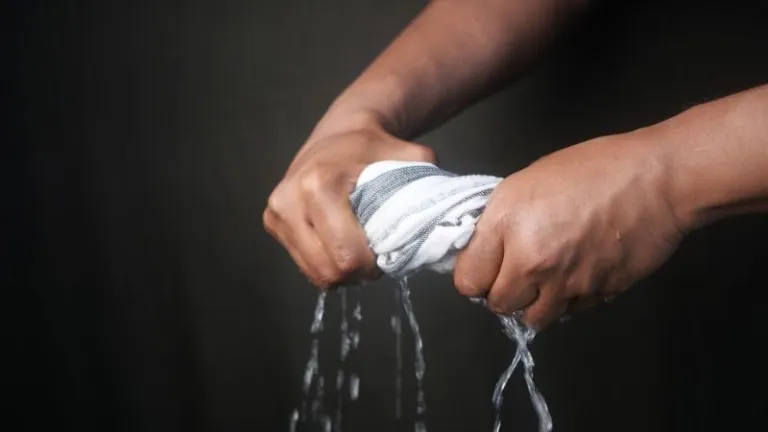 wringing a wet towel