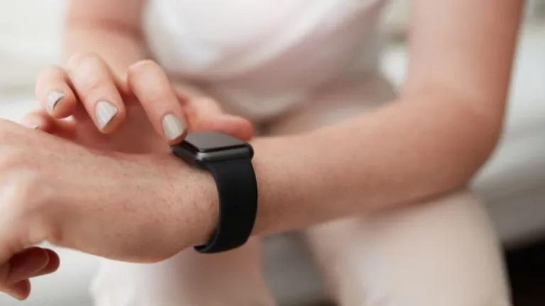 person adjusting smart watch