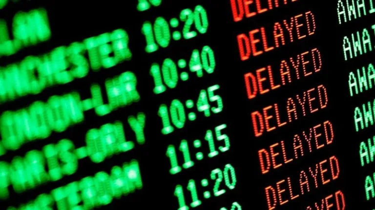 close up of information screen displayed delayed flights