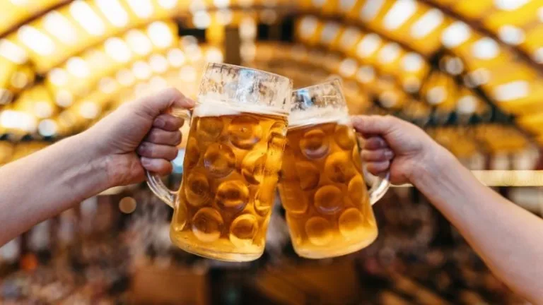 two people holding beer mugs in Oktoberfest in Germany