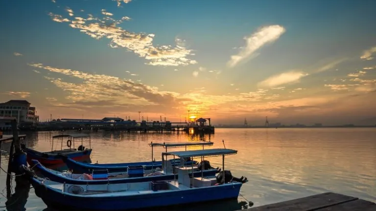 sunset over a jetty with boats