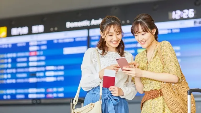 tourists using their phone in the airport