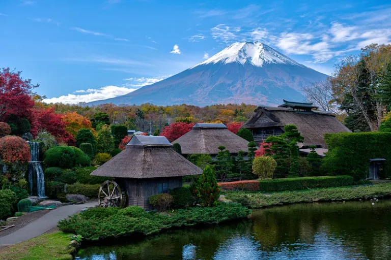 Traditional thatched-roof farmhouses and Japanese garden with Mount Fuji in autumn, Oshino Hakkai, Japan