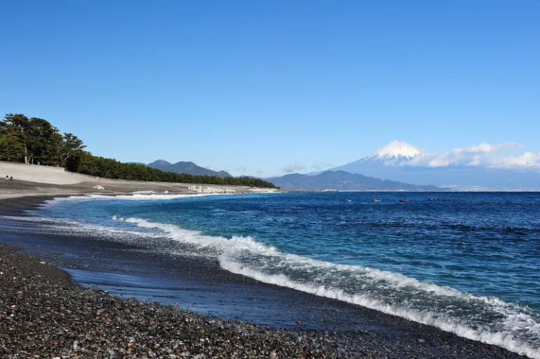 Mount Fuji viewed from Miho no Matsubara black pebble beach with ocean waves, Shizuoka, Japan