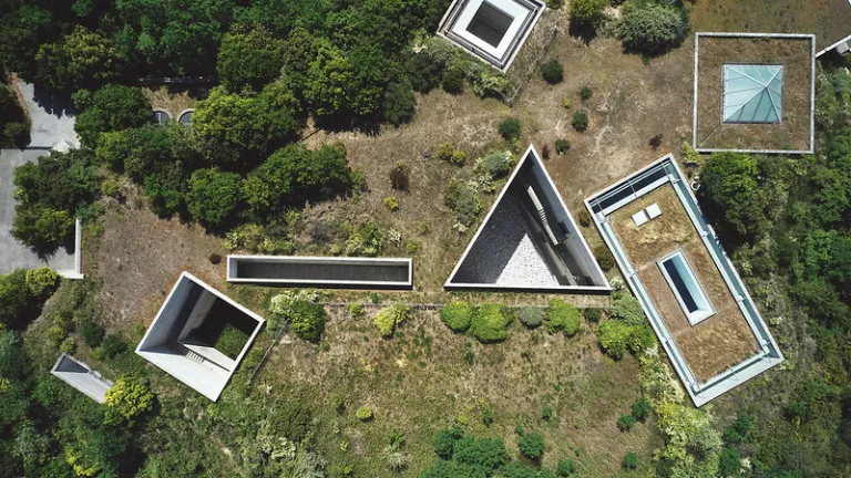Aerial view of Chichu Art Museum, showcasing Tadao Ando's geometric concrete architecture integrated into Naoshima's landscape.