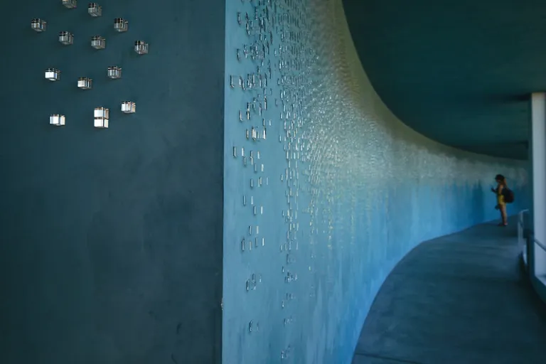 Curved gallery wall inside Benesse House, featuring a contemporary art installation within Tadao Ando's minimalist architecture.