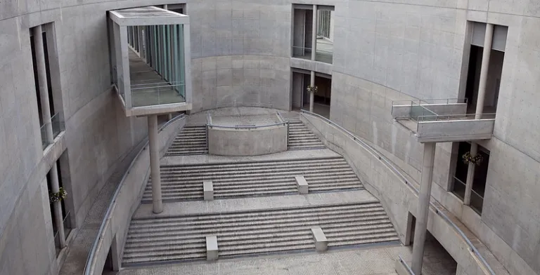 Central courtyard of Awaji Yumebutai, featuring Tadao Ando's exposed concrete architecture, sweeping staircases, and geometric design.