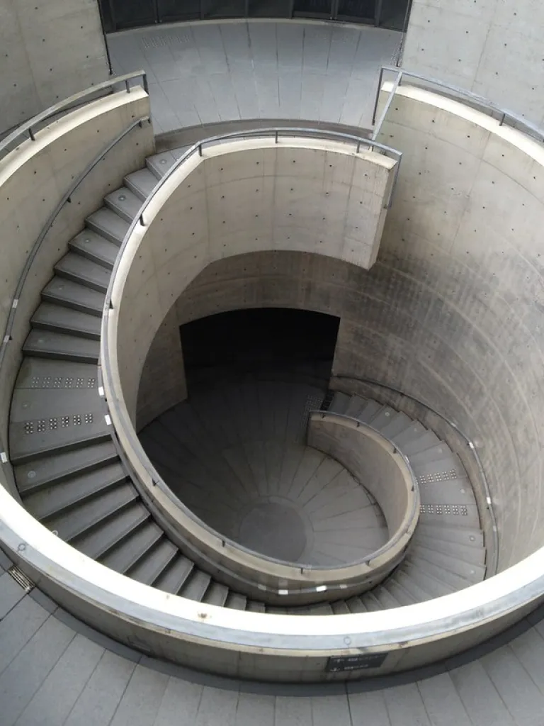 Spiral concrete staircase inside Hyogo Prefectural Museum of Art, showcasing Tadao Ando's signature geometric architecture.