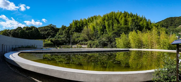 Reflecting pool at Awaji Yumebutai, where Tadao Ando's minimalist concrete design blends with the surrounding natural landscape.
