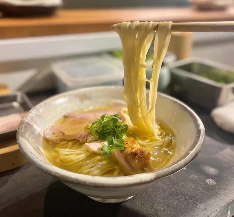 A bowl of shio ramen with handmade noodles, sliced pork, and clear broth at Japanese Ramen Gokan in Tokyo.