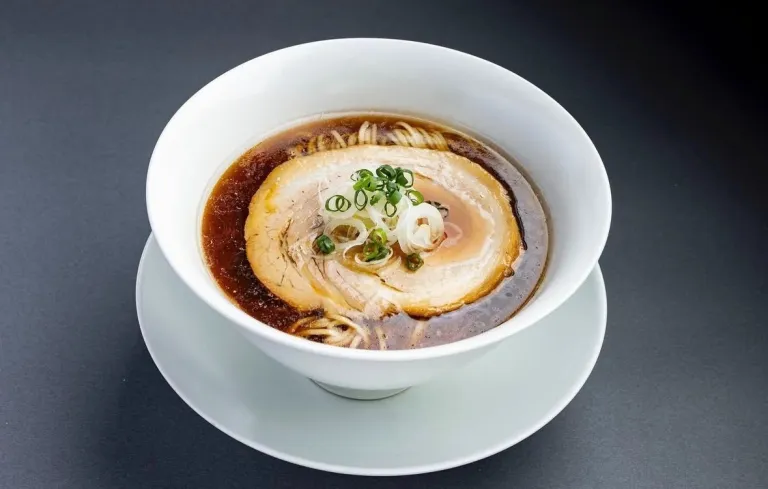 Signature tantanmen topped with sliced pork and spring onions at Sosakumenkobo NAKIRYU in Tokyo.