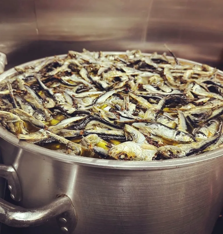 Pot of dried sardines simmering to prepare ramen broth at There Is Ramen in Ogikubo, Tokyo.