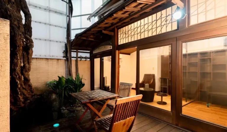 Rest area at Akebonoyu in Asakusa, Tokyo, featuring wooden seating, glass doors and a peaceful garden-like setting.