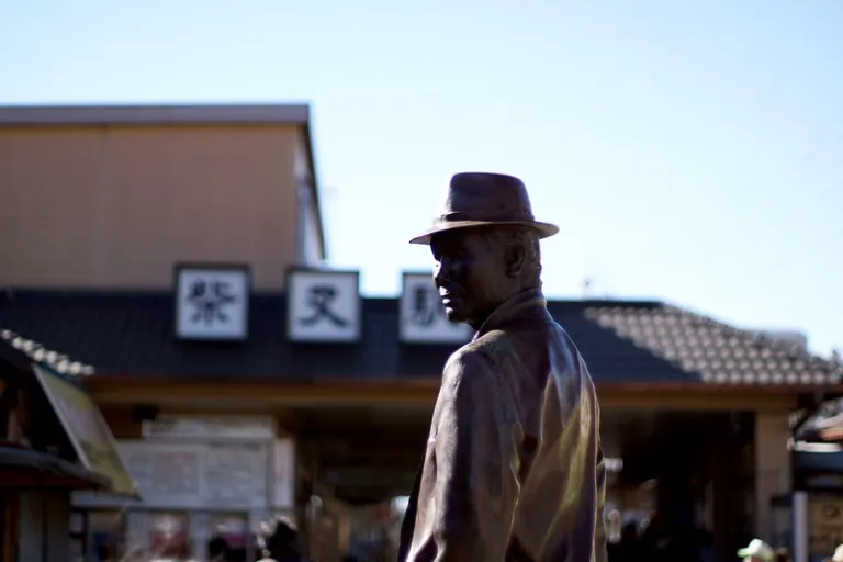 Statue of Tora-san standing in front of Shibamata Station in Tokyo, symbolising the neighbourhood&rsquo;s connection to classic Japanese cinema.