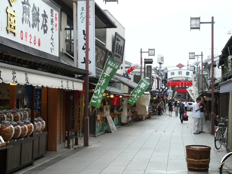 Taishakuten-Sando shopping street in Shibamata, lined with traditional shops and banners leading towards Shibamata Taishakuten Temple.