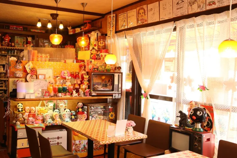 Interior of Cafe Sepia in Shibamata, decorated with colourful vintage toys, retro furniture and nostalgic Showa-era details.