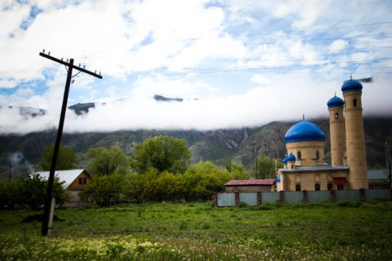 Mosque near the mountains and beautiful cloudly sky, Kazakhstan