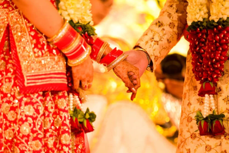 Closeup of indian wedding couple holding hands and promise to be together for lifetime.
