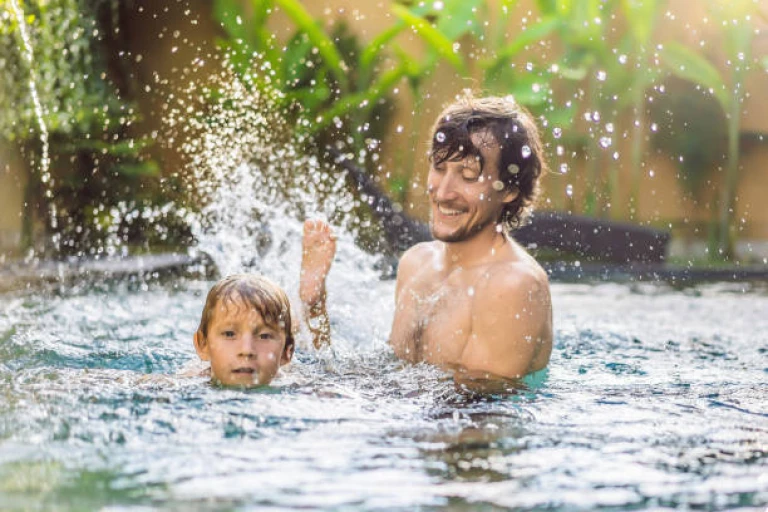 Dad and son have fun in the pool