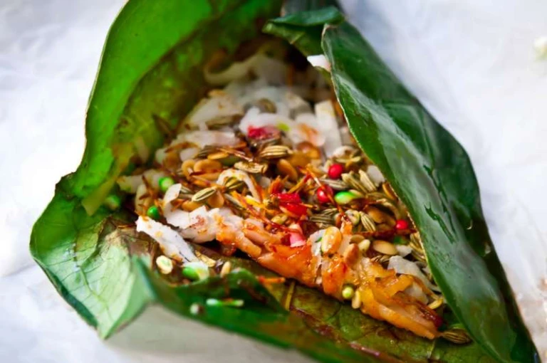 A betel leaf filled with various sweet and savory fillings 